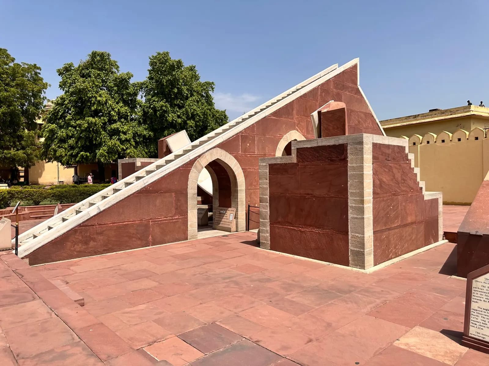 Red sandstone sundial instrument with a sloping gnomon at the Jantar Mantar observatory in Jaipur
