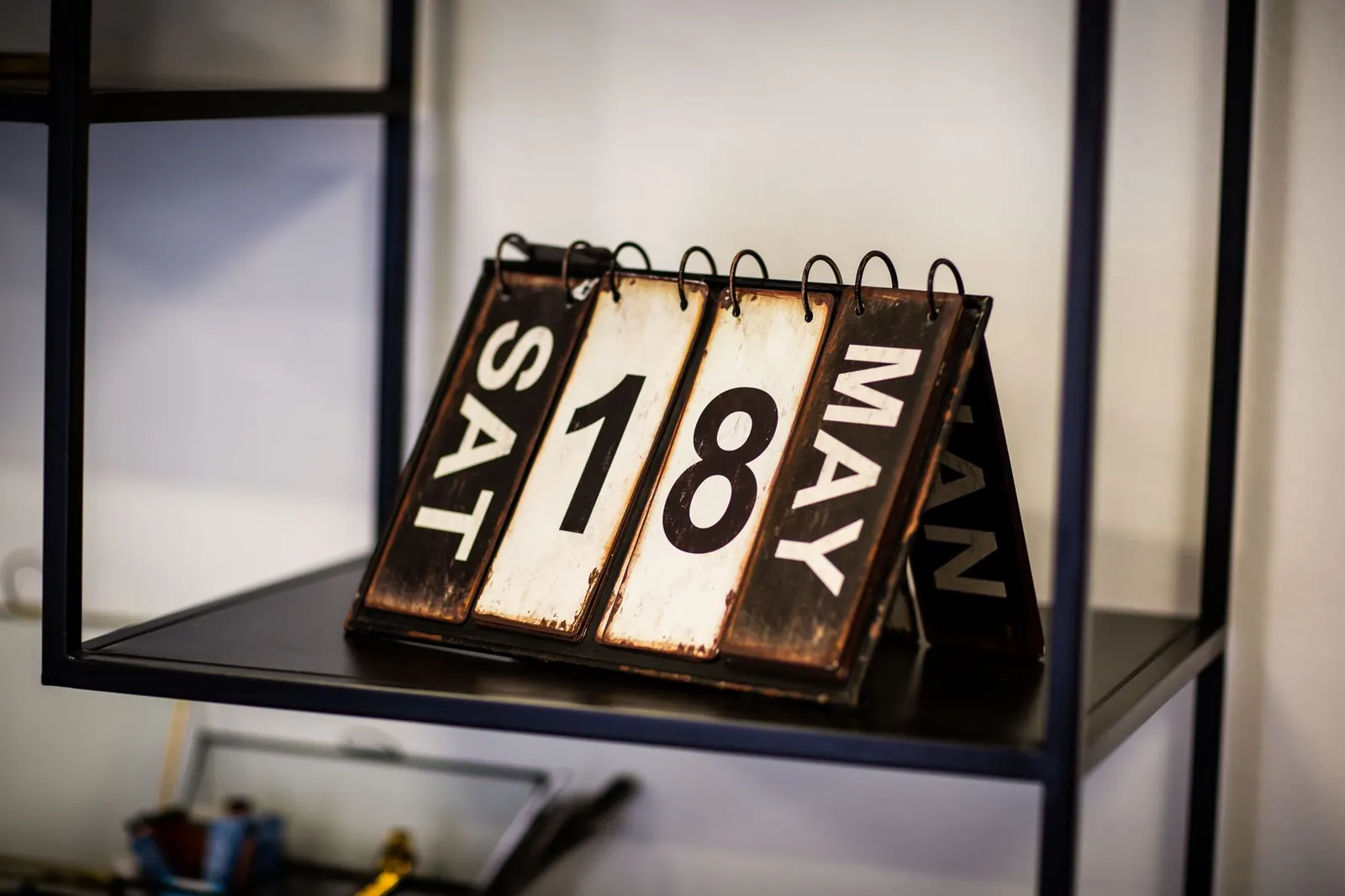 Old flip calendar on a shelf showing Saturday 18 May