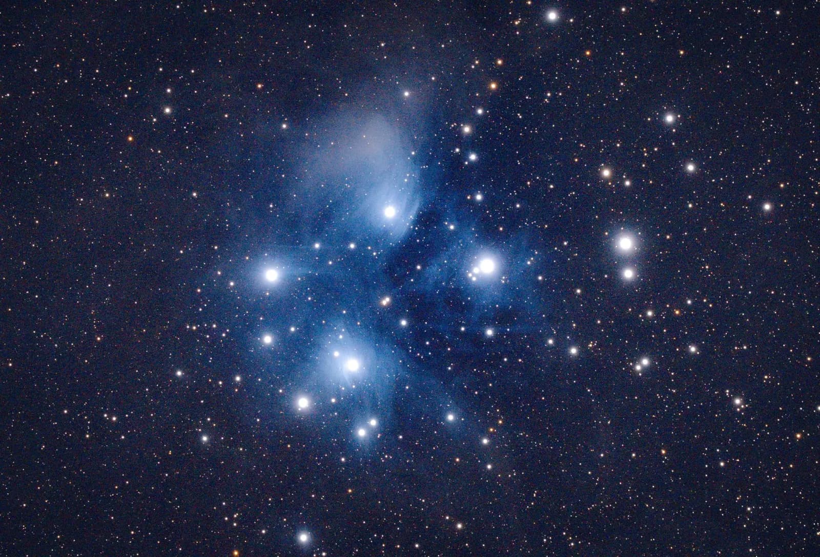 The Pleiades star cluster in the constellation Taurus, bright blue stars in a dark sky