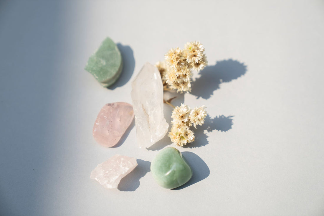 Pale pink rose quartz and clear quartz crystals resting on natural linen