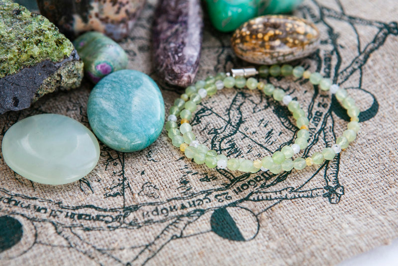 A flat lay of assorted natural gemstone bead bracelets in different colours
