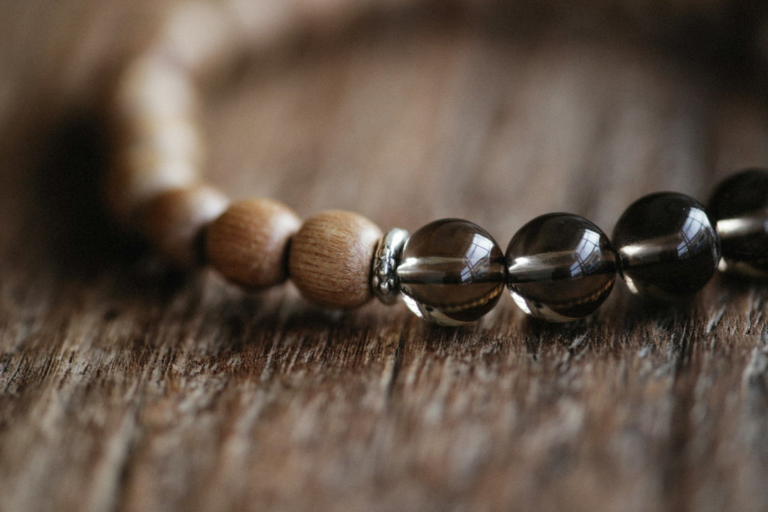 Golden-brown tiger eye and clear quartz bead bracelet resting on natural linen