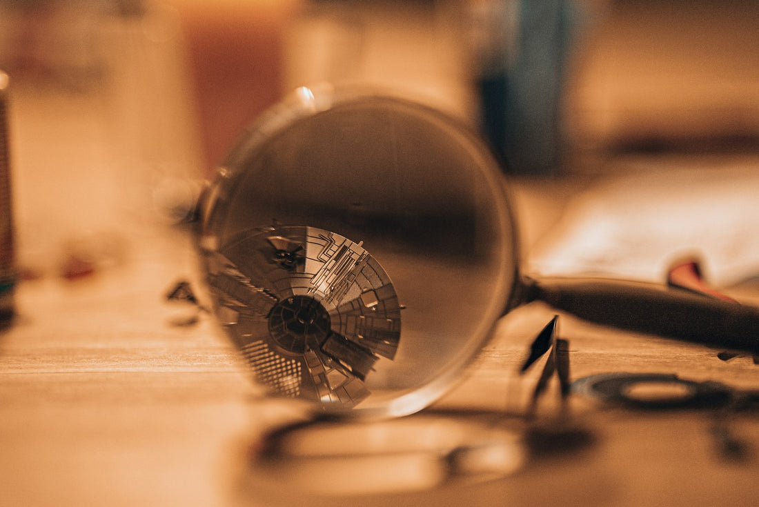 Magnifying glass used to inspect fine detail, as when verifying a bead